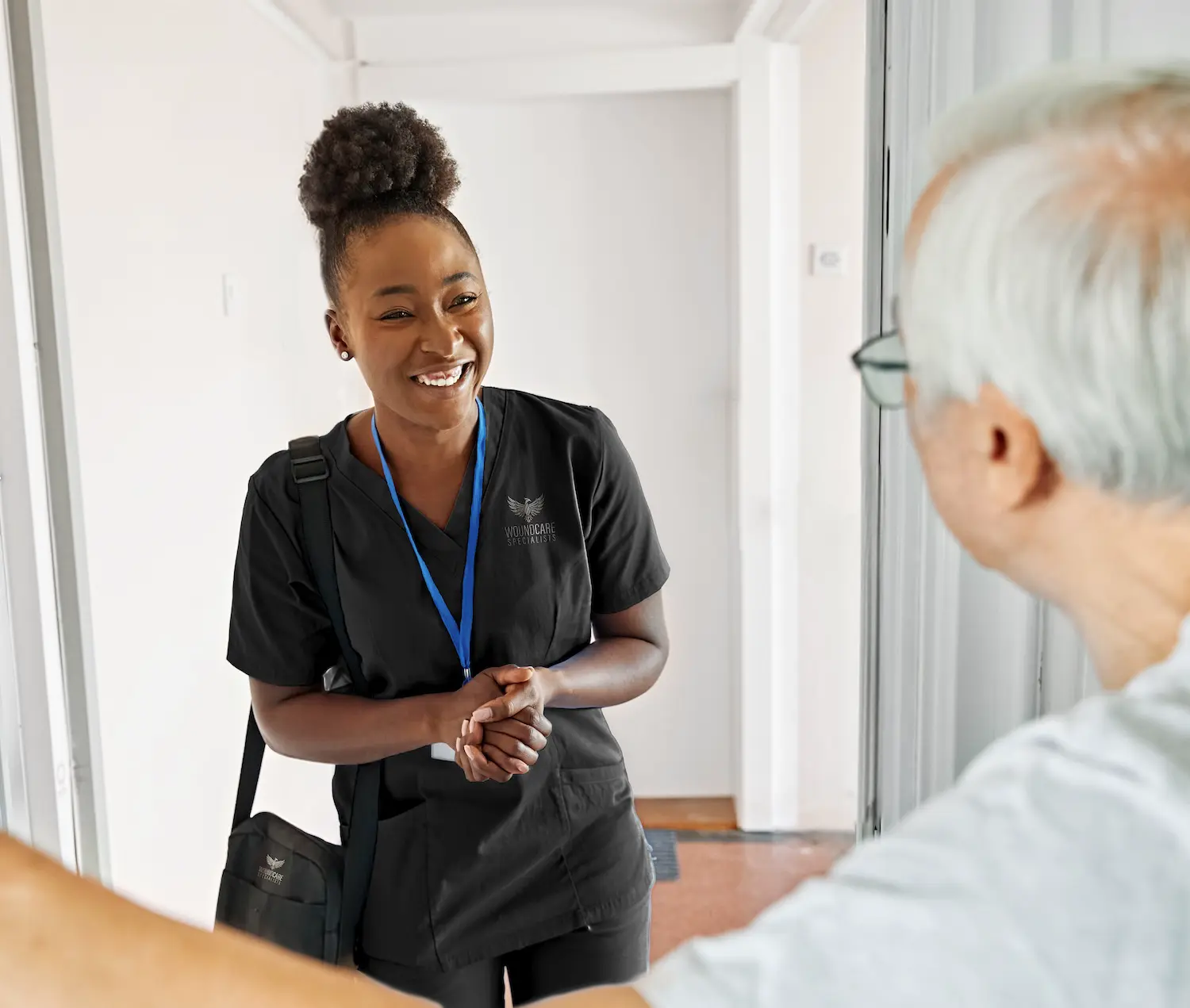 Wound care specialist providing in-home treatment to a home health patient
