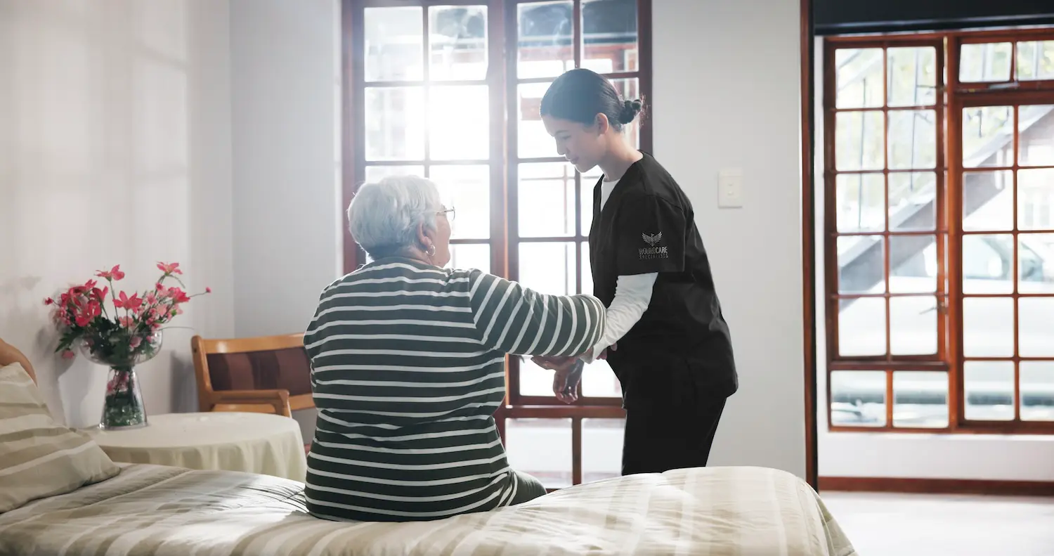 Specialist supporting a hospice patient with gentle wound care