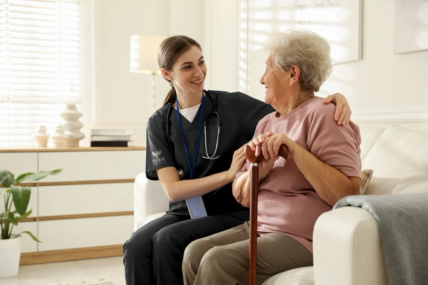 Wound specialist conducting bedside assessment at SNF