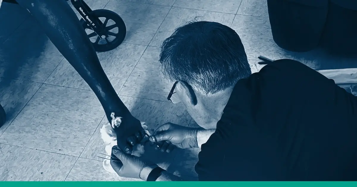 Dr. Lonnie Lassiter treats a chronic wound patient in their senior nursing facility.